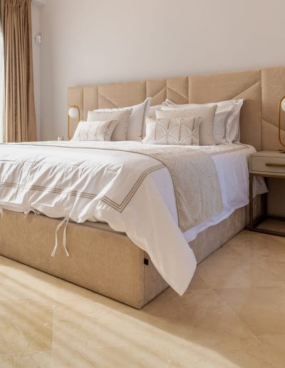 After: master bed with neutral styling