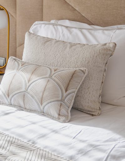After: textured pillows on bed