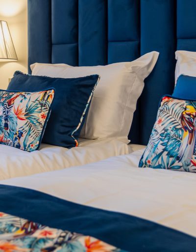 After: twin beds with blue headboard