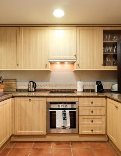 Before: fitted kitchen with oven and cabinets