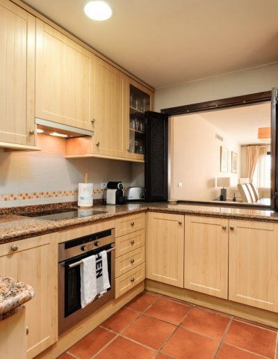 Before: kitchen with fridge and granite worktops