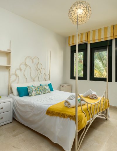 Before: bright bedroom with striped blind