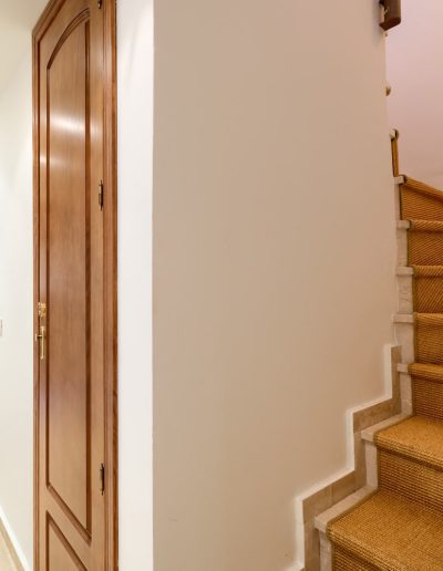 Before: hallway and carpeted stairs