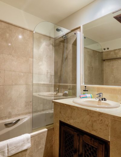 Before: tiled bathroom with shower-bath